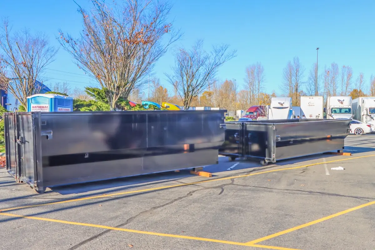 Professional dumpster rental service with roll-off container on residential driveway in Cambridge
